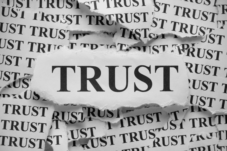 The word trust written multiple times on scraps of paper