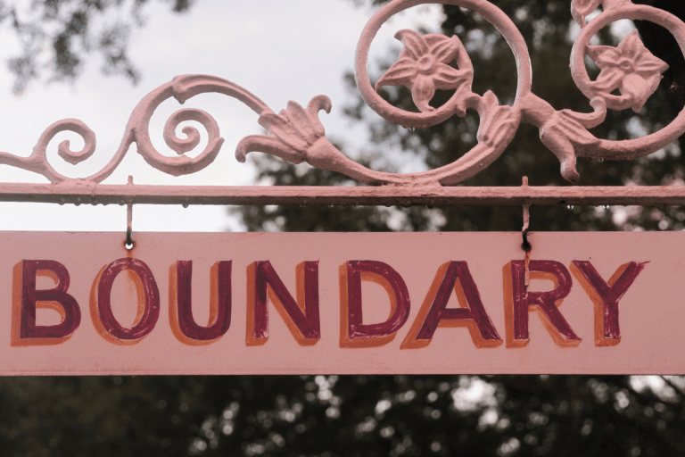 a pink sign with the word boundary on it.