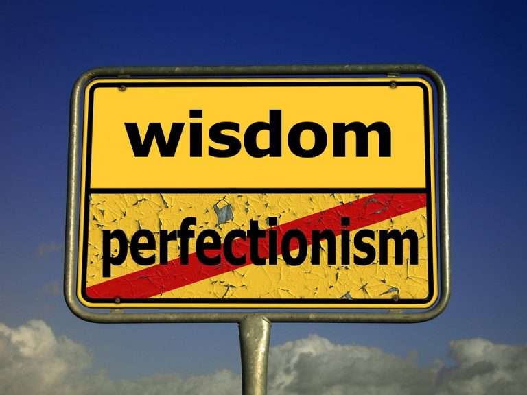 a road sign that says wisdom perfectionism.