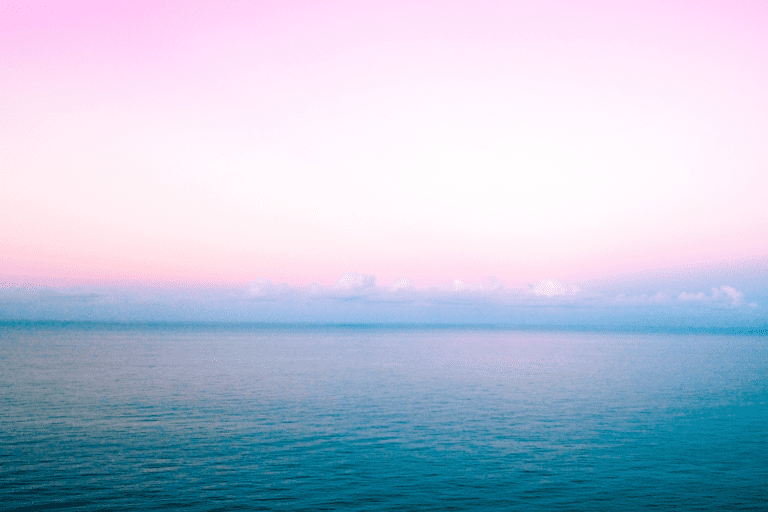 A pink and purple sky over a body of water.